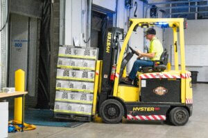 Forklift with a pallet of Joe IPA beer driving towards gate