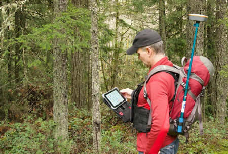 ruxton pack in the forest with tablet